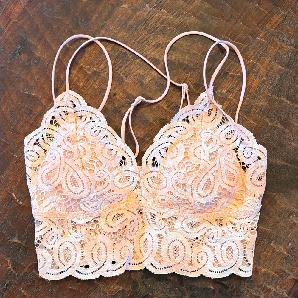 VS Pink. Lace Bralette. Criss cross back. Ivory, peach, pink blend. Never worn.